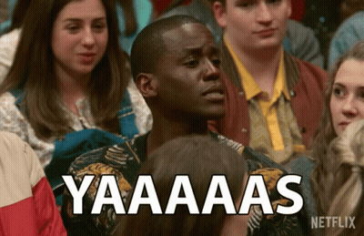 A Man Sitting In A Crowd With A Netflix Logo On The Bottom GIF