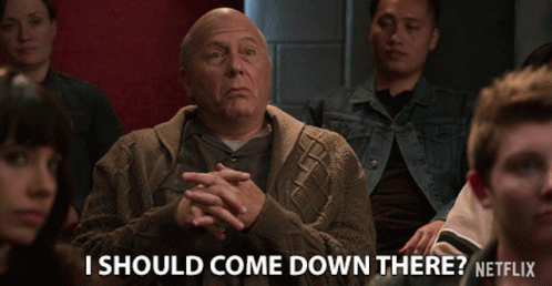 A Man Sitting In A Crowd With The Words " I Should Come Down There " Below Him GIF