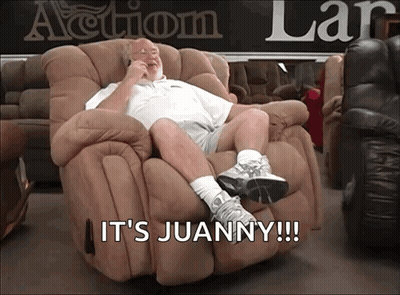 A Man Sitting In A Recliner With The Words It 'S Juanny Written Below Him GIF