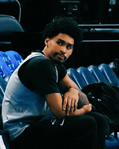 A Man Sitting In A Stadium With The Name Jaeejv Written On His Jersey GIF