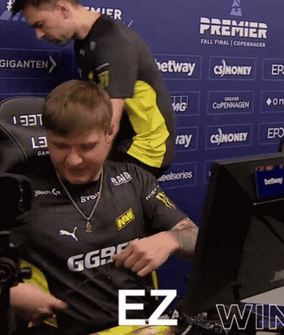 A Man Sitting In Front Of A Blue Wall That Says Premier Fall Final Copenhagen On It GIF