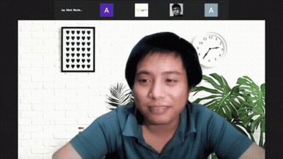 A Man Sitting In Front Of A Clock With The Letters A And A Next To Him GIF