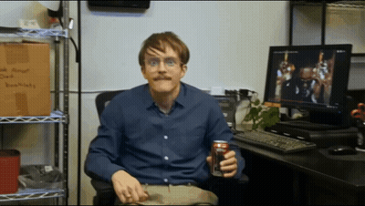 A Man Sitting In Front Of A Computer Holding A Can Of Diet Coke GIF