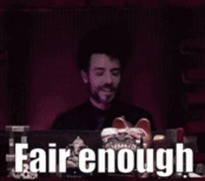 A Man Sitting In Front Of A Computer With The Words Fair Enough Written On The Screen Behind Him GIF