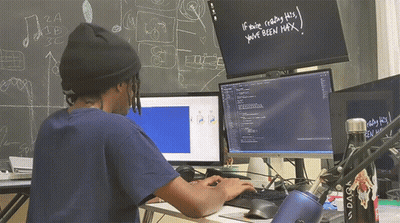 A Man Sitting In Front Of A Computer With The Words If You 'Re Reading This You 'Ve Been Max Written On A Blackboard GIF