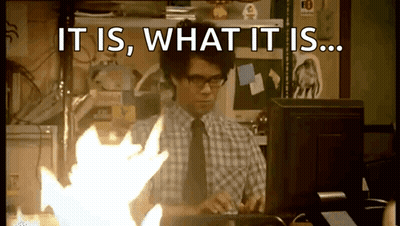 A Man Sitting In Front Of A Computer With The Words " It Is What It Is " On The Screen GIF