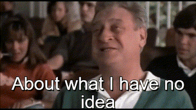A Man Sitting In Front Of A Crowd With The Words About What I Have No Idea GIF