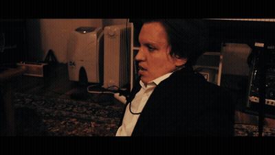 A Man Sitting In Front Of A Desk With The Word Monday On It GIF