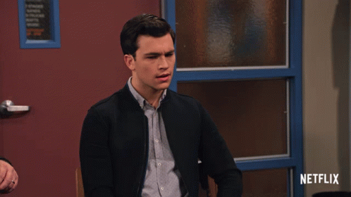 A Man Sitting In Front Of A Door With Netflix Written On The Bottom GIF