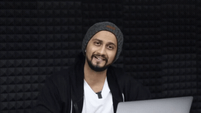 A Man Sitting In Front Of A Laptop With The Word Haha On The Bottom Right GIF