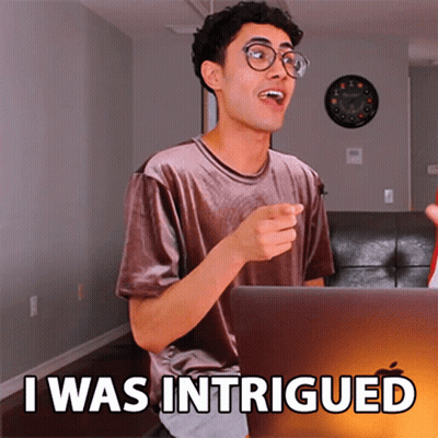 A Man Sitting In Front Of A Laptop With The Words I Was Intrigued On The Screen GIF