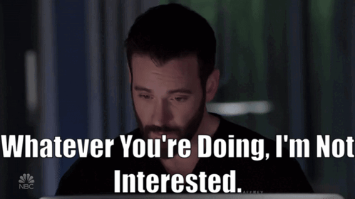 A Man Sitting In Front Of A Laptop With The Words Whatever You 'Re Doing I 'M Not Interested Written Below GIF