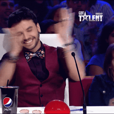 A Man Sitting In Front Of A Microphone With A Cup Of Pepsi In Front Of Him GIF