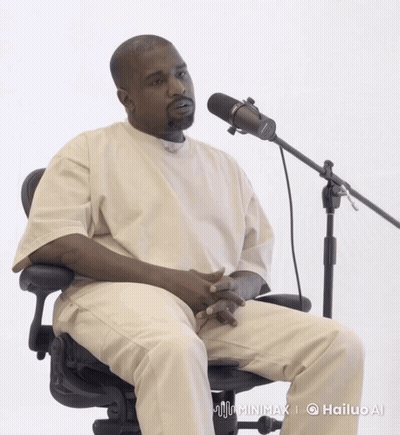 A Man Sitting In Front Of A Microphone With A Hailup Ai Logo On The Bottom Right GIF