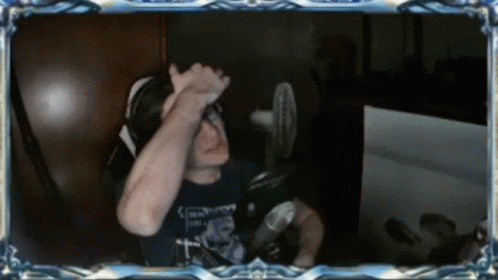 A Man Sitting In Front Of A Microphone With A Shirt That Says ' Emperor ' On It GIF