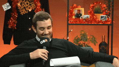 A Man Sitting In Front Of A Microphone With Gbr On It GIF