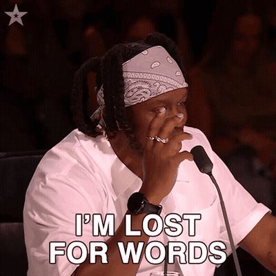 A Man Sitting In Front Of A Microphone With The Words I 'M Lost For Words GIF