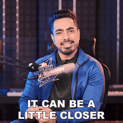 A Man Sitting In Front Of A Microphone With The Words It Can Be A Little Closer GIF