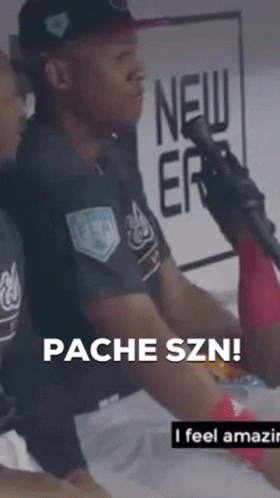 A Man Sitting In Front Of A Microphone With The Words " Pacheszn " On The Bottom Right GIF