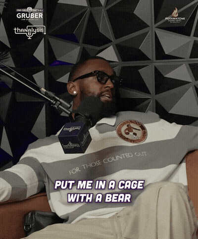 A Man Sitting In Front Of A Microphone With The Words Put Me In A Cage With A Bear On The Bottom GIF