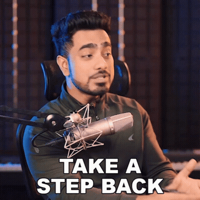 A Man Sitting In Front Of A Microphone With The Words Take A Step Back Above Him GIF