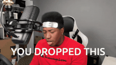 A Man Sitting In Front Of A Microphone With The Words " You Dropped This " On The Bottom GIF