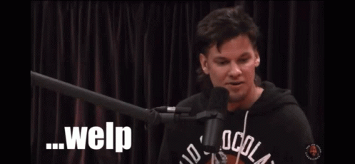 A Man Sitting In Front Of A Microphone With Welp Written On The Screen Behind Him GIF