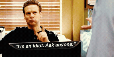 A Man Sitting In Front Of A Monitor That Says I 'M An Idiot Ask Anyone GIF