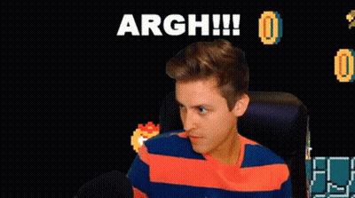 A Man Sitting In Front Of A Screen That Says Argh GIF