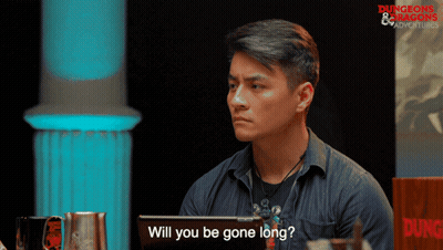 A Man Sitting In Front Of A Sign That Says Dungeons & Dragons GIF