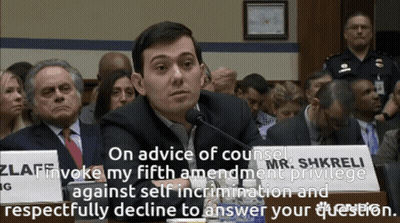 A Man Sitting In Front Of A Sign That Says On Advice Of Counsel GIF