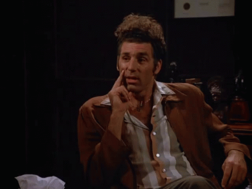 A Man Sitting In Front Of A Sign That Says That 'S True On It GIF