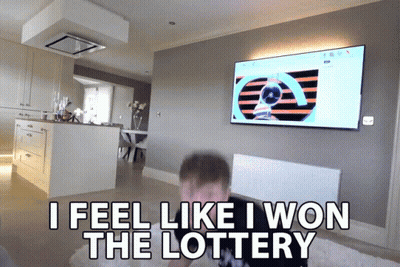 A Man Sitting In Front Of A Television With The Words " I Feel Like I Won The Lottery " Above Him GIF