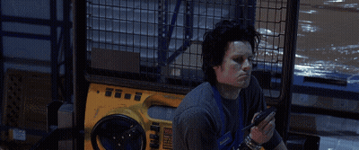 A Man Sitting In Front Of A Yellow Machine With The Words Well Paint Me Intrigued GIF