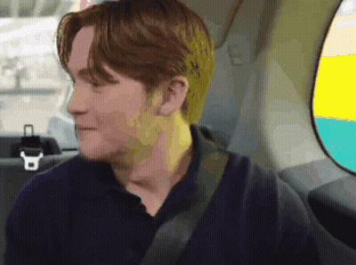 A Man Sitting In The Back Seat Of A Car With A Seat Belt On GIF