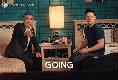 A Man Sitting On A Bed Next To Another Man Who Is Sitting On A Bed With The Word Going In Front Of Them GIF
