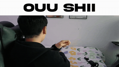 A Man Sitting On A Bed With The Words Ouu Shii Written Above Him GIF