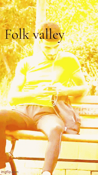 A Man Sitting On A Bench With The Word Folk Valley Written On The Bottom GIF