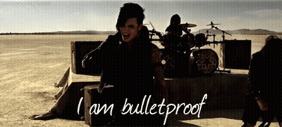 A Man Sitting On A Box With The Words I Am Bulletproof On The Bottom GIF