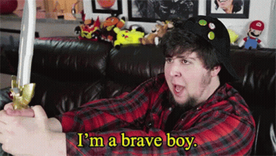 A Man Sitting On A Couch Holding A Sword With The Words I 'M A Brave Boy Above Him GIF