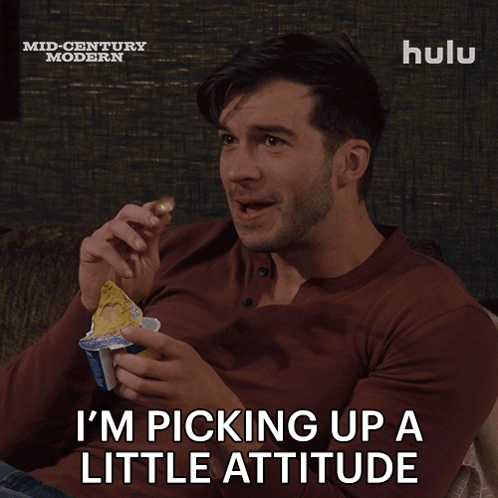 A Man Sitting On A Couch With A Hulu Logo On The Bottom Right GIF