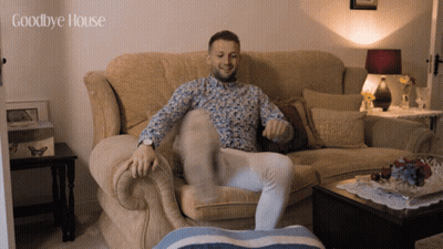 A Man Sitting On A Couch With The Words Goodbye House Written Above Him GIF