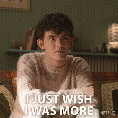 A Man Sitting On A Couch With The Words I Just Wish I Was More Written Below Him GIF