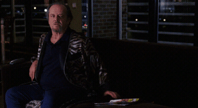 A Man Sitting On A Couch With The Words Watch Your F * * Kin Mouth On The Bottom GIF
