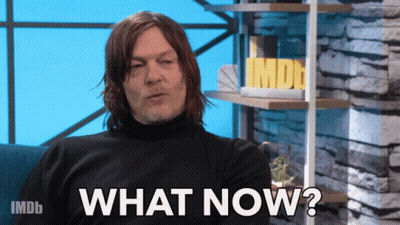 A Man Sitting On A Couch With The Words " What Now " On The Screen GIF