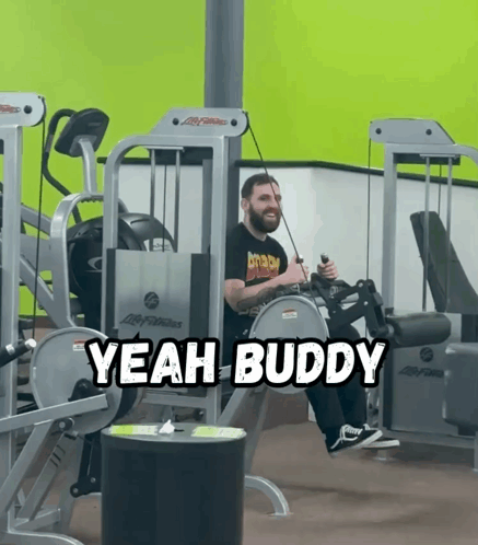 A Man Sitting On A Machine With The Words Yeah Buddy Written Above Him GIF