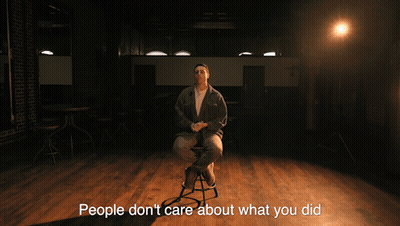 A Man Sitting On A Stool With The Words " They Want To Know What You 'Re Going To Do Next " GIF