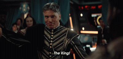 A Man Sitting On A Throne With The Words " The King " Written On It GIF