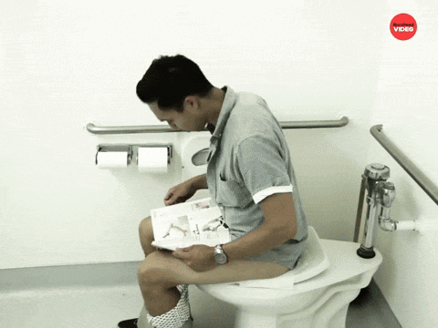A Man Sitting On A Toilet Reading A Magazine With A Red Video Logo Above Him GIF