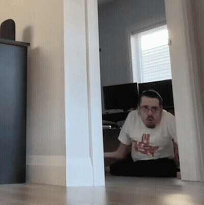 A Man Sitting On The Floor Wearing A T-Shirt That Says ' U.s.f. ' On It GIF